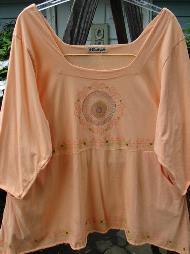Barclay Be There Top featuring Pinwheel Power design in Pastel Tangerine, Size 2. Organic cotton piece with squared neckline, empire waist, full pleats, and skirt flair. Vintage Blue Fish Clothing from BlueFishFinder.com.