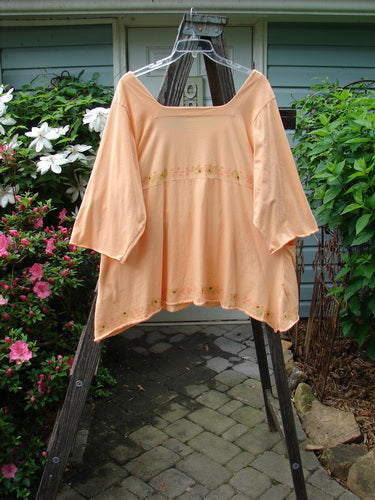 Barclay Be There Top with Pinwheel Power theme, Pastel Tangerine, Size 2, features a deep square neckline, empire waist, wide pleats, and a flowing skirt flair. Vintage Blue Fish Clothing at BlueFishFinder.com.