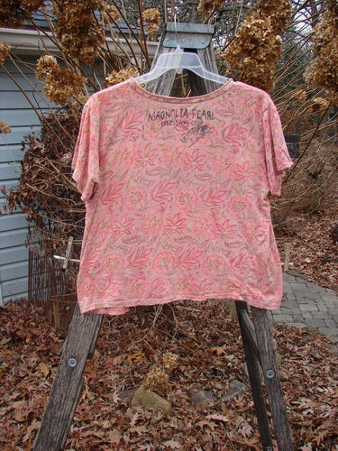 Magnolia Pearl NWT Cotton Jersey Boyfriend Tee Remi Block Print Sunset Flower OSFA, displayed on a step-ladder, features a leaf-print pattern and distressing, offering a soft drapey fit with unique seam detailing.