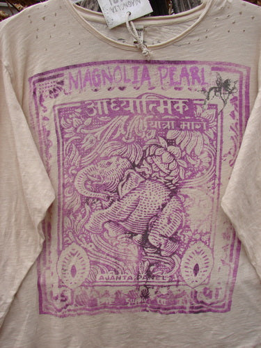 Magnolia Pearl NWT Cotton Jersey Boyfriend Tee Spiritual Walk Carousel OSFA features a magenta-purple Ganesha graphic and Devanāgarī script, on a cream long-sleeve with distressed edges and wrap waist seam.
