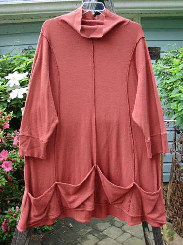 Barclay Thermal Quad Drop Pocket Tunic Dress Unpainted Brick Size 2, featuring a double-layered turtleneck, widening lower hem, four drop pockets, and curved stitching, displayed on a hanger.