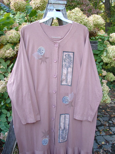 1994 Column Dress Magical Nature Cliff Size 2: A long pink robe with a full button front. Elongating paint design in a nature theme. Flattering flounce and V-shaped neckline. Longer sleeves and U-shaped upper shoulder seam.