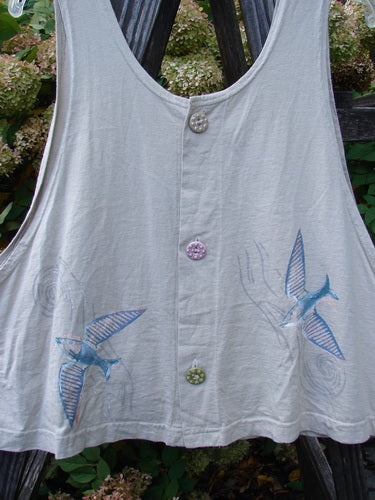 1999 Pinwheel Vest Love Dove Dust Size 2: A white shirt with birds on it. Porcelain painted buttons, deeper arm openings, slightly flared hemline, and a cropped length. Organic cotton.