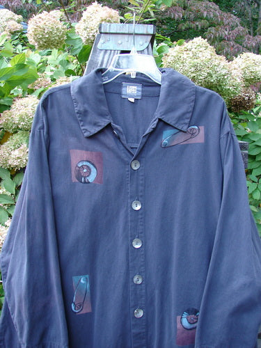 2001 P3 Top Junk Drawer Licorice Size 1: A long-sleeved shirt on a swinger. Soft cotton twill with six abalone shell buttons. Rounded hemline and tailored shoulder seam. Signature Blue Fish 2001 stamp.