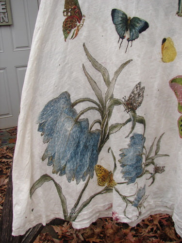 Magnolia Pearl NWT Cotton Jersey Lana Tank Dress features drooping blue bell flowers and butterflies, showcasing its A-line silhouette and raw edges, reflecting Bluefishfinder's vintage-inspired, expressive fashion ethos.