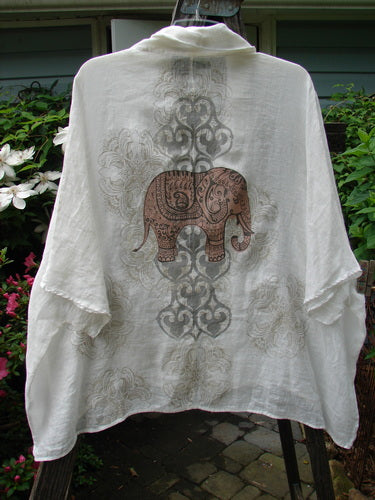 Barclay Linen Open Front Sweep Jacket featuring a detailed elephant theme on a white shirt. Dolman sleeves, rounded hemline, and generous rear print. Vintage Blue Fish Clothing.