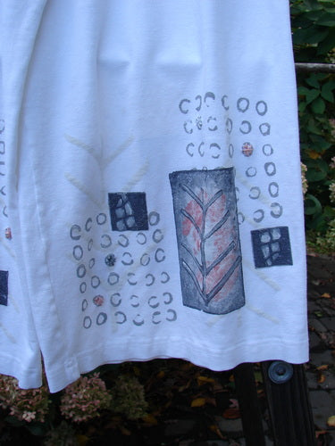 Image alt text: Barclay PMU Rayon Lycra Side Pocket Crop Panel Duo - a white shirt with drawings on it, paired with matching pants.