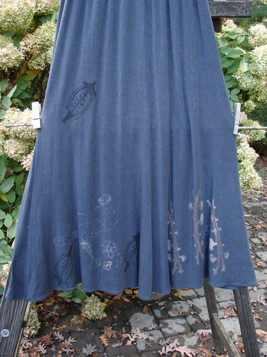 1998 Rayon Lycra Botanicals Tendril Mayflower Duo Onyx Size 1: A blue skirt with botanical theme paint and a design on a rack.