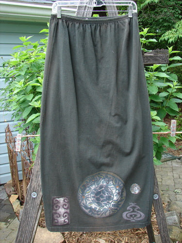 A vintage 1992 Straight Skirt from BlueFishFinder in Black Sand. Features metallic medallion theme paint, elastic waistline, and Blue Fish signature patch. Size 1, 36 length. Image shows skirt on ladder.