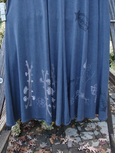 1998 Rayon Lycra Botanicals Tendril Mayflower Duo Onyx Size 1: A blue skirt with a design on it and a blue towel on a rack.