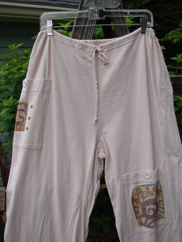 1996 Seed Planting Pant Abstract Garden Birch Bark Size 1 hanging on a clothesline, showcasing three front pockets with blue buttons, a drawstring waist, and relaxed fit.