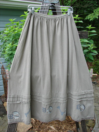 1995 Wish Skirt Ball & Bone Rain Cloud Size 2 hanging on a clothesline, showcasing a sweeping A-line shape, full elastic waistline, deep side pockets, and antique lace accents.