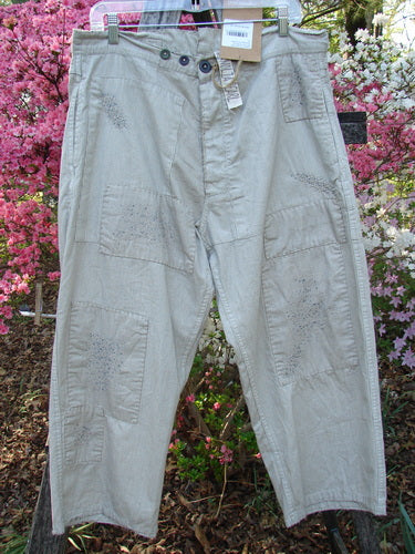 Magnolia Pearl NWT European Denim Lilou Trouser Natural Pinstripe OSFA features a relaxed, straight-leg cut with patchwork detailing, adjustable button fly, and raw edges, showcasing unique craftsmanship and vintage appeal.
