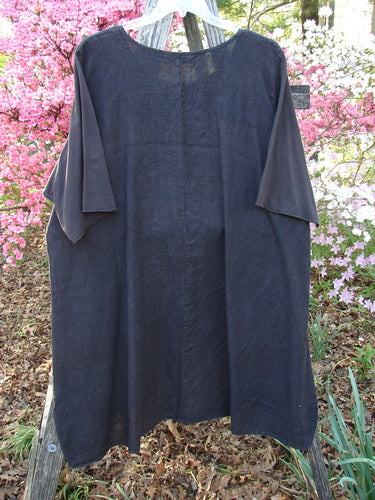 Barclay Linen Cotton Sleeve Milkmaid Dress, Black Noir Size 2, with sunrise pleats and a curved empire waist, elegantly displayed on a ladder, showcasing its A-line cut and diagonal pockets.