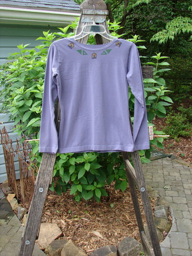 1996 Long Sleeved Cotton Lycra Layering Top Ram Mulberry Size 1 displayed on a wooden ladder outdoors, showcasing its fitted, shapely design with a rounded shallow neckline and tapering waist.