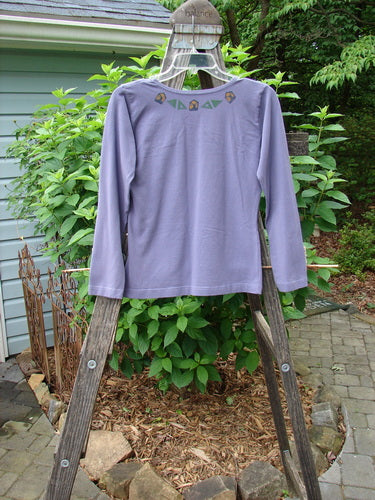 1996 Long Sleeved Cotton Lycra Layering Top Ram Mulberry Size 1 displayed on a wooden swing, highlighting its fitted and shapely design with a rounded neckline and tapering waist.