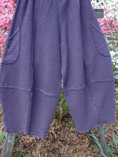 Barclay Patched Crepe Sectional Pocket 4 Square Pant Diamond Brum Size 1, showcasing a textured, loose-fitting cut with unique diamond draping from the knee, large side pockets, and elastic waistband, hanging outdoors.