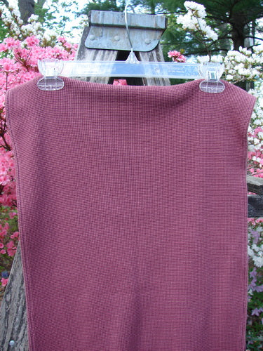 1992 Thermal Scarf Unpainted Mulberry OSFA hangs outdoors, clipped to a clear hanger. This waffle-knit fabric panel showcases its generous length and sweet curly edges against blooming azalea shrubs in the background.