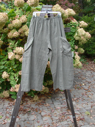 Barclay Linen Side Pocket Summer Pant on wooden stand, size 1. Unpainted Green Stone. Full elastic waistline, wrap exterior pockets, slight crop length.