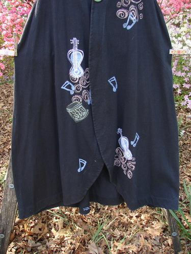 1996 State Fair Vest Music Festival Storm Size 1, featuring a black knee-length design with stylized musical motifs in pale hues, hung outdoors, showcasing its A-line shape and unique hemline.