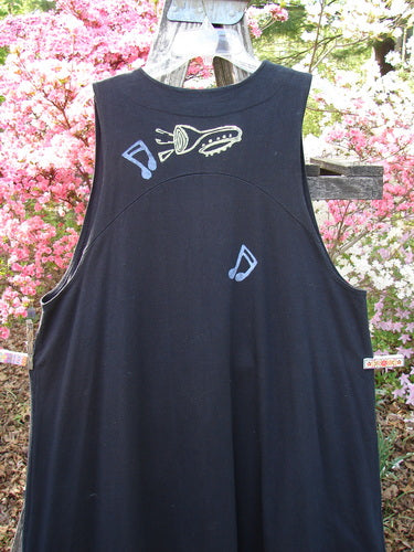 1996 State Fair Vest Music Festival Storm Size 1: A black, sleeveless vest with pale blue musical-note motifs and flashlight graphic on back, showcasing an oversized button and A-line shape, hanging outdoors.