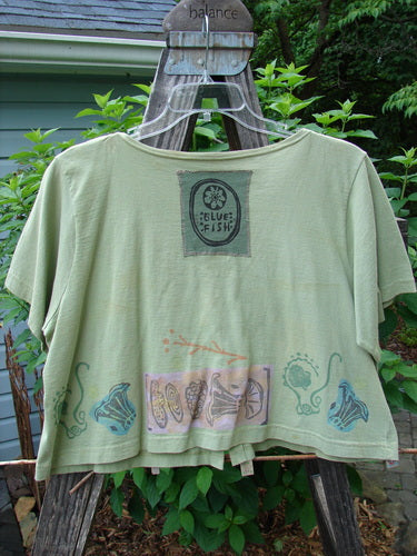 Vintage 1993 Blue Fish Travel Top in Kelp, altered to size 2. Features a beach treasure theme with a signature blue fish patch. Wooden accented buttons add a unique touch. Perfect for layering.