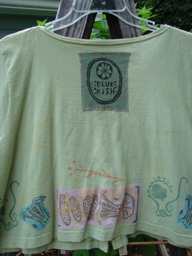 Vintage 1993 Travel Top with Beach Treasure Theme, altered size 2, featuring a scoop neckline, crop shape, Blue Fish 93 patch, and wooden buttons. From BlueFishFinder's collection of unique, expressive clothing. Bust 48, Waist 50, Sweep 52, Length 20.