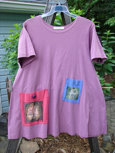 1997 Montage Dress Abstract Crocus Size 1 with an A-line shape, featuring two oversized painted pockets, vintage buttons, and a rounded neckline, made from medium-weight organic cotton.