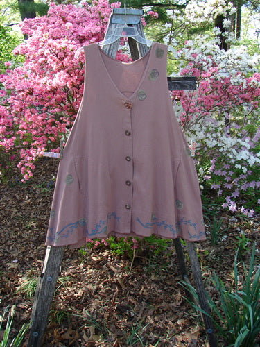 1993 Short Column Vest Floral Vine Rosewood OSFA displayed on a rustic ladder. Features include a swingy A-line shape, decorative embroidery, front buttons, patch pockets, and a banded hemline.