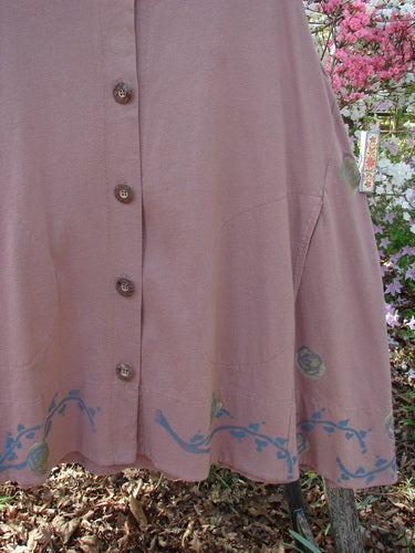 1993 Short Column Vest Floral Vine Rosewood OSFA, displaying a dusty-rose button-front with a blue vine motif along the hem, hangs outdoors, capturing Bluefishfinder.com's signature vintage style and creative expression.