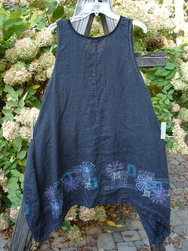 Barclay Linen Lace Pinafore Jumper with Daisy Border, Size 0. A blue dress with a flower design on a wooden rack.