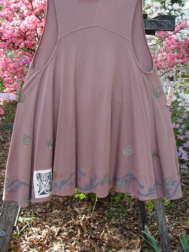 1993 Short Column Vest Floral Vine Rosewood OSFA draped on a ladder, showcasing its swingy shape, scalloped blue print, floral motifs, vintage clay button, and almost hidden kangaroo pockets with Blue Fish label.