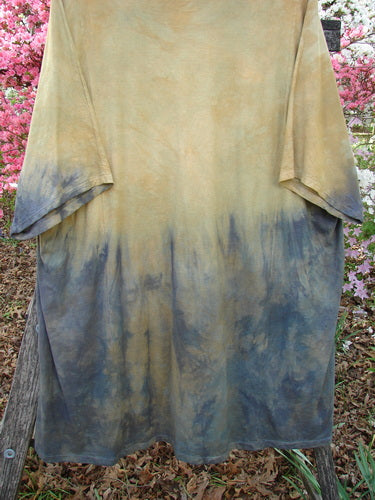 Barclay Art Tunic Tee Mottled Sun Field and Night OSFA showcases a two-tone design with loose drop shoulders, a rounded neckline, and varied hem, suspended outdoors against flowering shrubs.