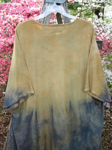 Barclay Art Tunic Tee Mottled Sun Field and Night OSFA: Loose-fitting, dip-dyed tunic with golden-yellow top fading to slate-blue hem, hanging amidst flowering shrubs, embodying Bluefishfinder.com's vintage, creative ethos.