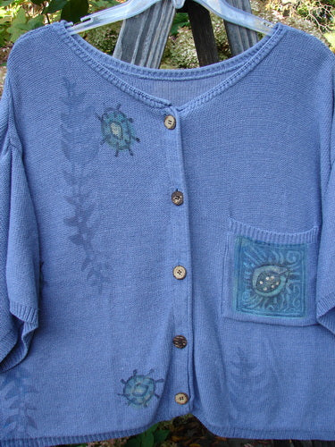 1995 Short Sleeved Cardigan Sweater with colorful buttons, variegated yarns, and friendly garden critter theme paint.