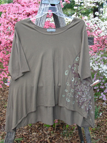 Barclay Hi Low Top Side Art Curly Cue Bark Size 1 displayed outdoors, features a loose fit, asymmetrical hem, and subtle circular design, showcasing Bluefishfinder.com’s vintage-inspired style and organic cotton craftsmanship.