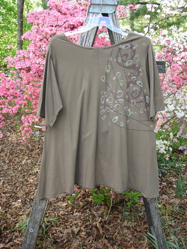Barclay Hi Low Top Side Art Curly Cue Bark Size 1 displayed on a wooden ladder, showcases a scooped neckline, abstract bead pattern, and sweeping A-line shape, embodying Bluefishfinder.com's vintage, creative style.