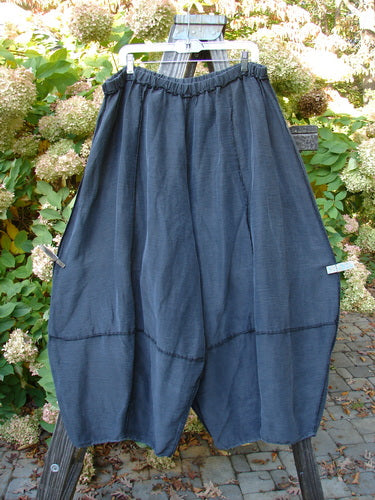 Barclay Silk Reverse Stitch 4 Square Pant on clothesline, made of polished silk, with belled lowers, exterior stitchery, and a unique bottom cut.