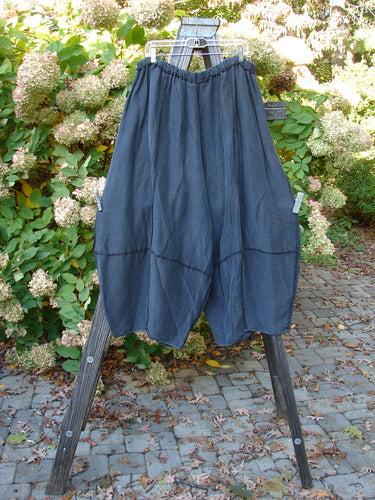 Barclay Silk Reverse Stitch 4 Square Pant on wooden stand, with full elastic waistline, belled lowers, exterior stitchery, and unique bottom cut.