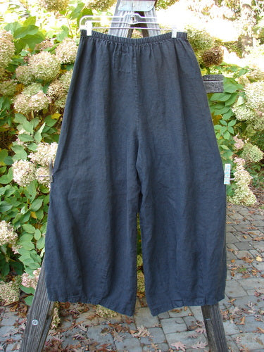 Barclay Linen Crop Drawstring Dimension Pant on a fence, size 1. Billowing lowers, crop length, unpainted and pocketless.