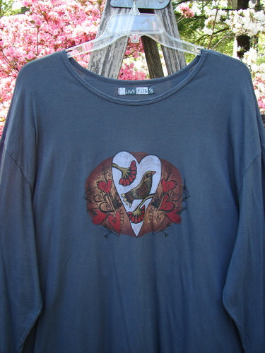 Barclay Long Sleeved Studio Tee Metallic Love Dove Steel Grey OSFA displayed on a hanger, showcasing a heart graphic with birds and floral swirls, representing Bluefishfinder.com's vintage-inspired, expressive style.