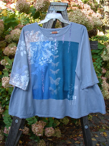 A Three Quarter Sleeved Crop A Lined Top in Sky Grey, featuring a butterfly design, sweet curly edgings, and a rounded neckline. Made from mid-weight organic cotton. Perfect condition. Size 1.