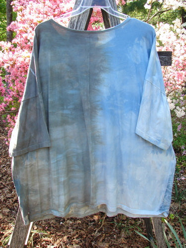 Barclay Center Seam Wide Line Tee in Windy Bonsai Mottled Day Storm, displayed outdoors on a stepladder. The T-shirt features a wide, boxy shape with significant drop shoulders and seamless front and back.