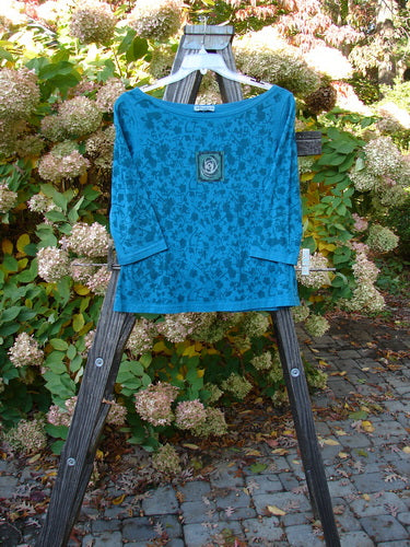Aqua Teal Barclay Cotton Lycra Boatneck Tiny Slim Tee with rose vine paint and single rose art on front. Three quarter length sleeves. Size 0.