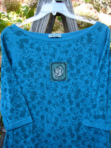 Aqua teal Barclay Boatneck Tiny Slim Tee with rose vine theme paint and front single rose art. Three quarter length sleeves and a slimmer bodice. Bust 38, waist 36, hips 42. Length 23 inches.