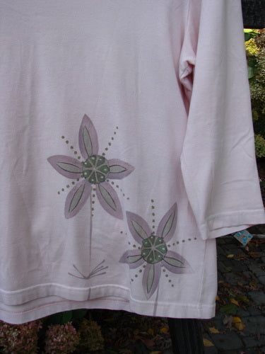Barclay Cotton Lycra Three Quarter Sleeved A Line Tee Double Daisy Pink Tile Size 1: A white shirt with purple flowers, featuring a close-up of a flower design.