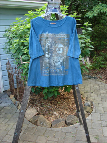 Barclay Modern Slim Tee Top Pansy Mottled Teal Size 1 displayed on a wooden ladder, featuring three-quarter sleeves, hip flare, rounded hemline, and contour pansy theme paint.