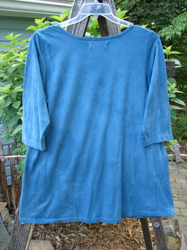 Barclay Modern Slim Tee Top Pansy Mottled Teal Size 1 on a clothes rack, showcasing three-quarter length sleeves and a unique rounded hemline.