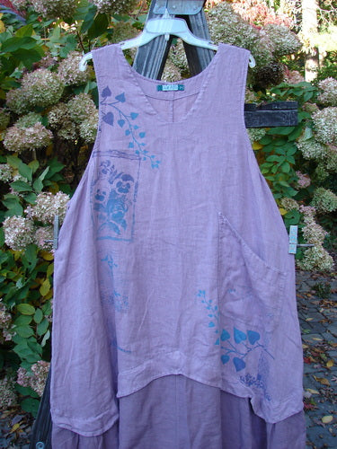 A lavender Barclay PMU Linen Explorer Jumper with a pansy theme paint. Features include a scoop neckline, full bodice overlay, billowy lower sweep, and a drawcord back. Size 2.