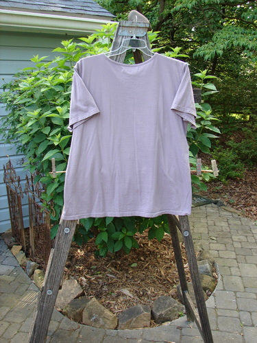 Barclay Short Sleeved Tee Leaf Branch Lilac Size 0 displayed on a wooden ladder, showcasing its detailed leaf branch design on mid-weight organic cotton.